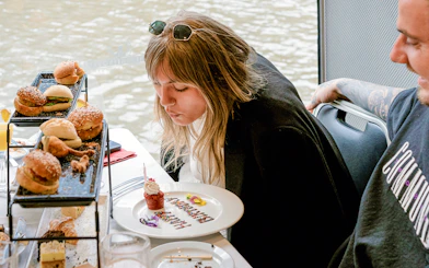 Guest enjoying a cupcake on a Bottomless Brunch Cruise in Melbourne.