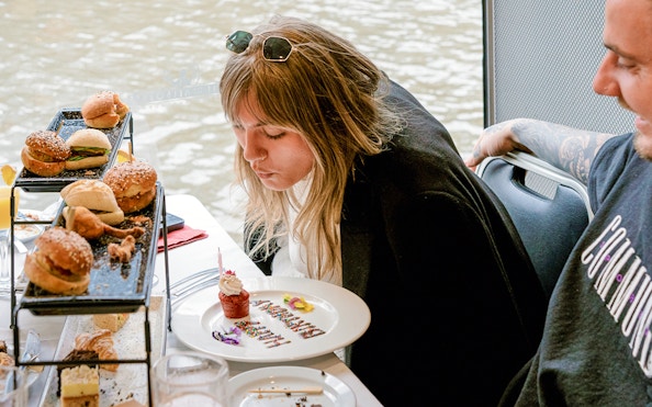 Guest enjoying a cupcake on a Bottomless Brunch Cruise in Melbourne.