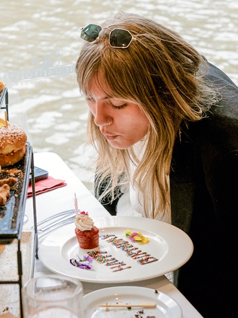 Guest enjoying a cupcake on a Bottomless Brunch Cruise in Melbourne.
