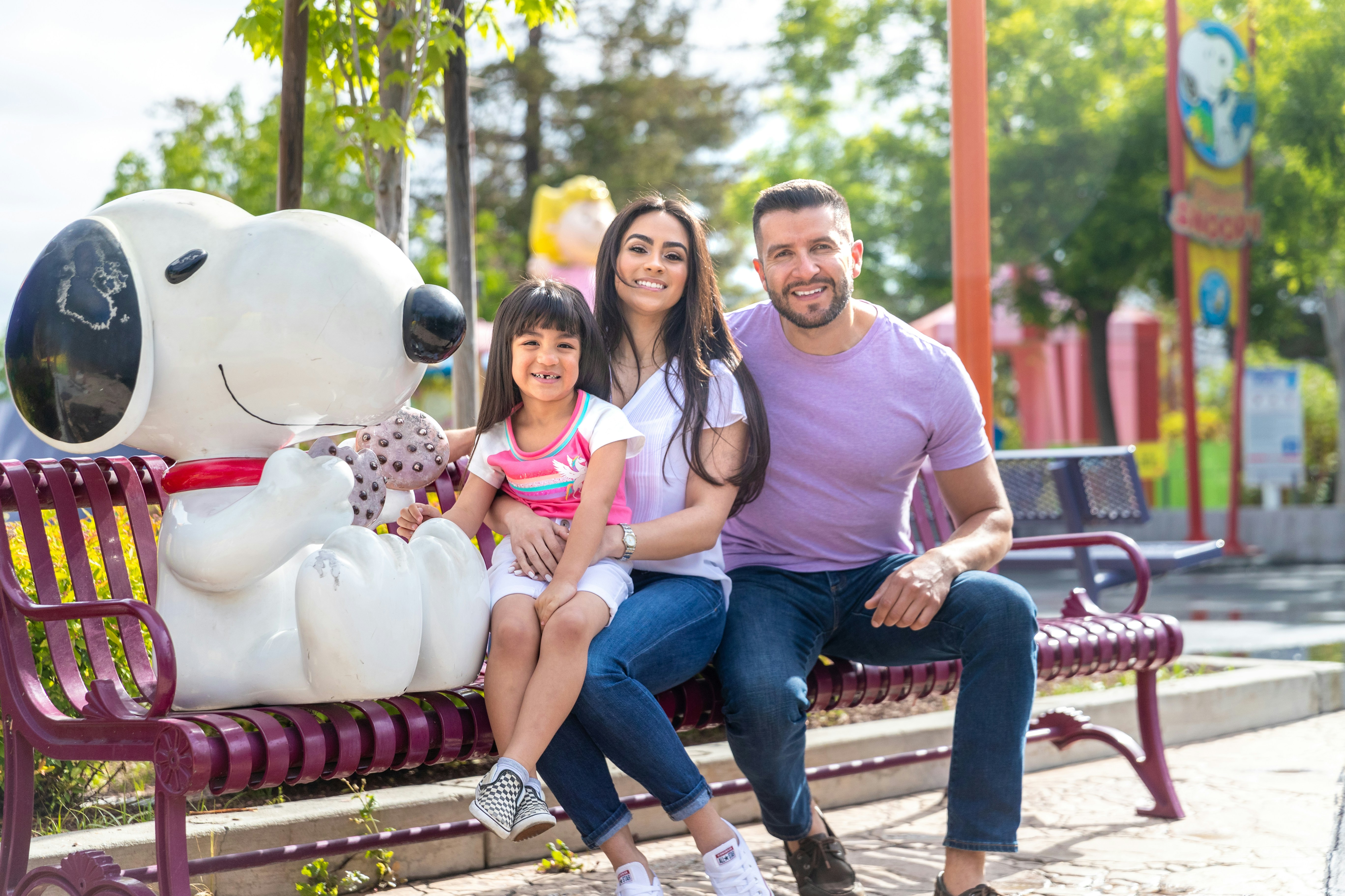 Family sitting with Snoopy statue