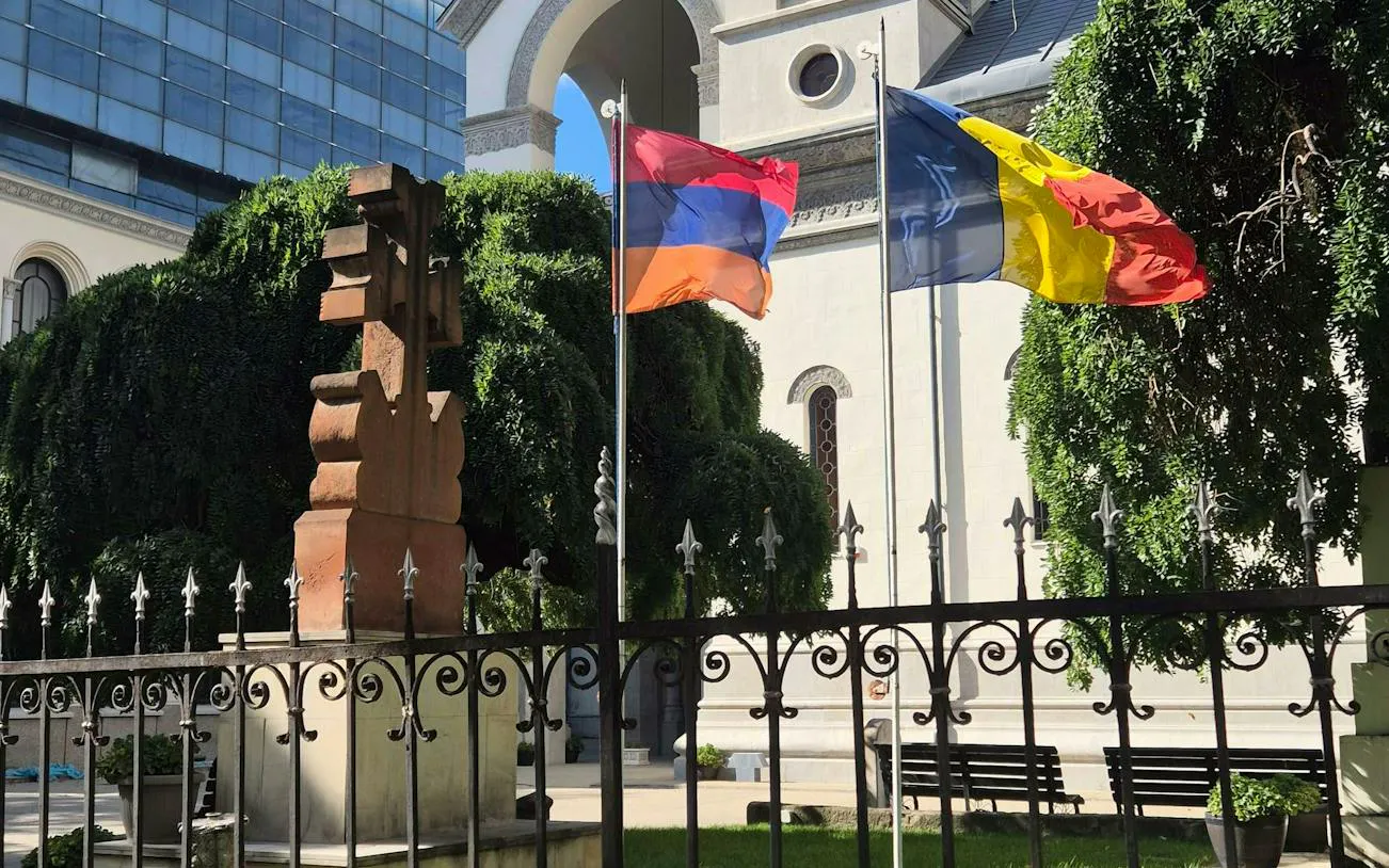 Armenian cross stone and flags in Bucharest's Armenian Quarter.