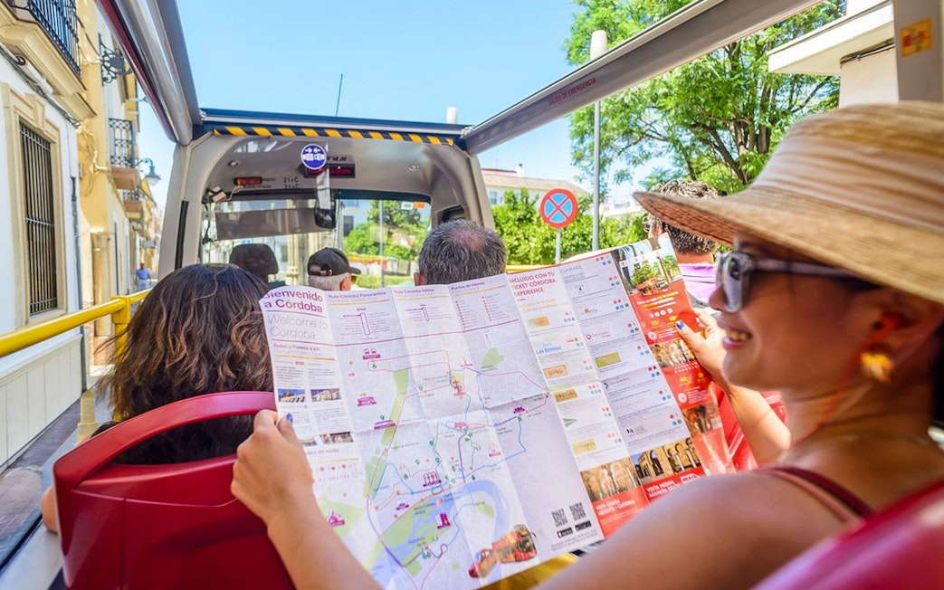 Woman reading a map on Cordoba city hop-on hop-off bus tour.