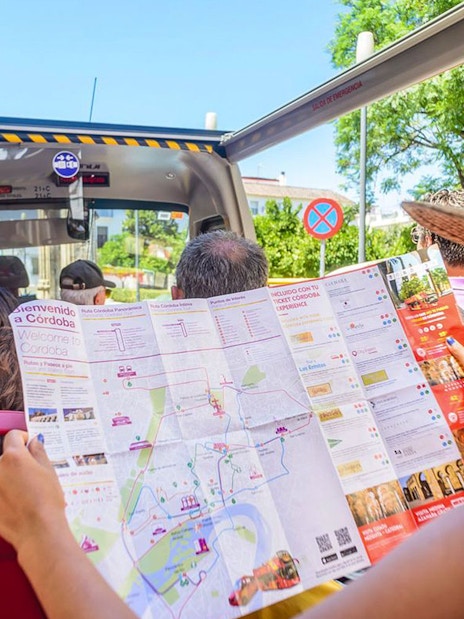 Woman reading a map on Cordoba city hop-on hop-off bus tour.