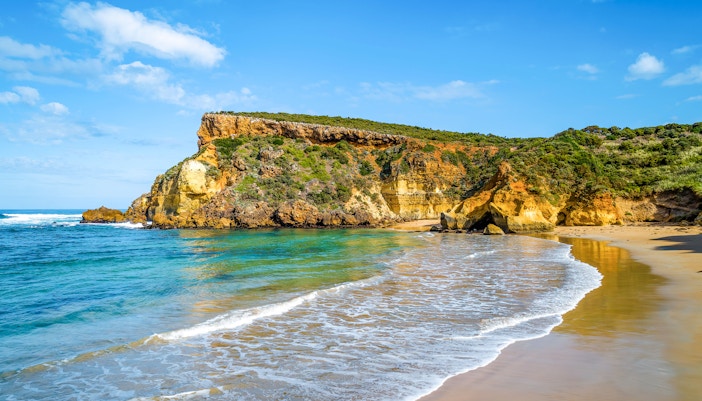 Childers Cove beach along Great Ocean Road, Australia, with waves crashing against cliffs.