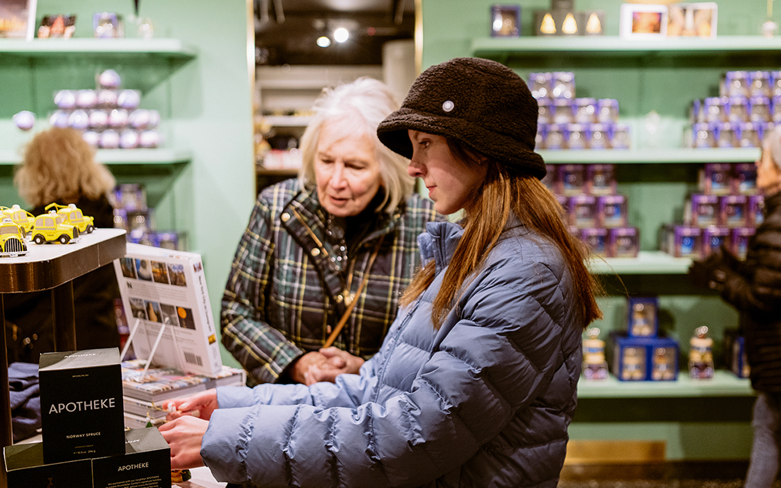 Visitors browsing souvenirs at Top of the Rock gift shop, New York City.