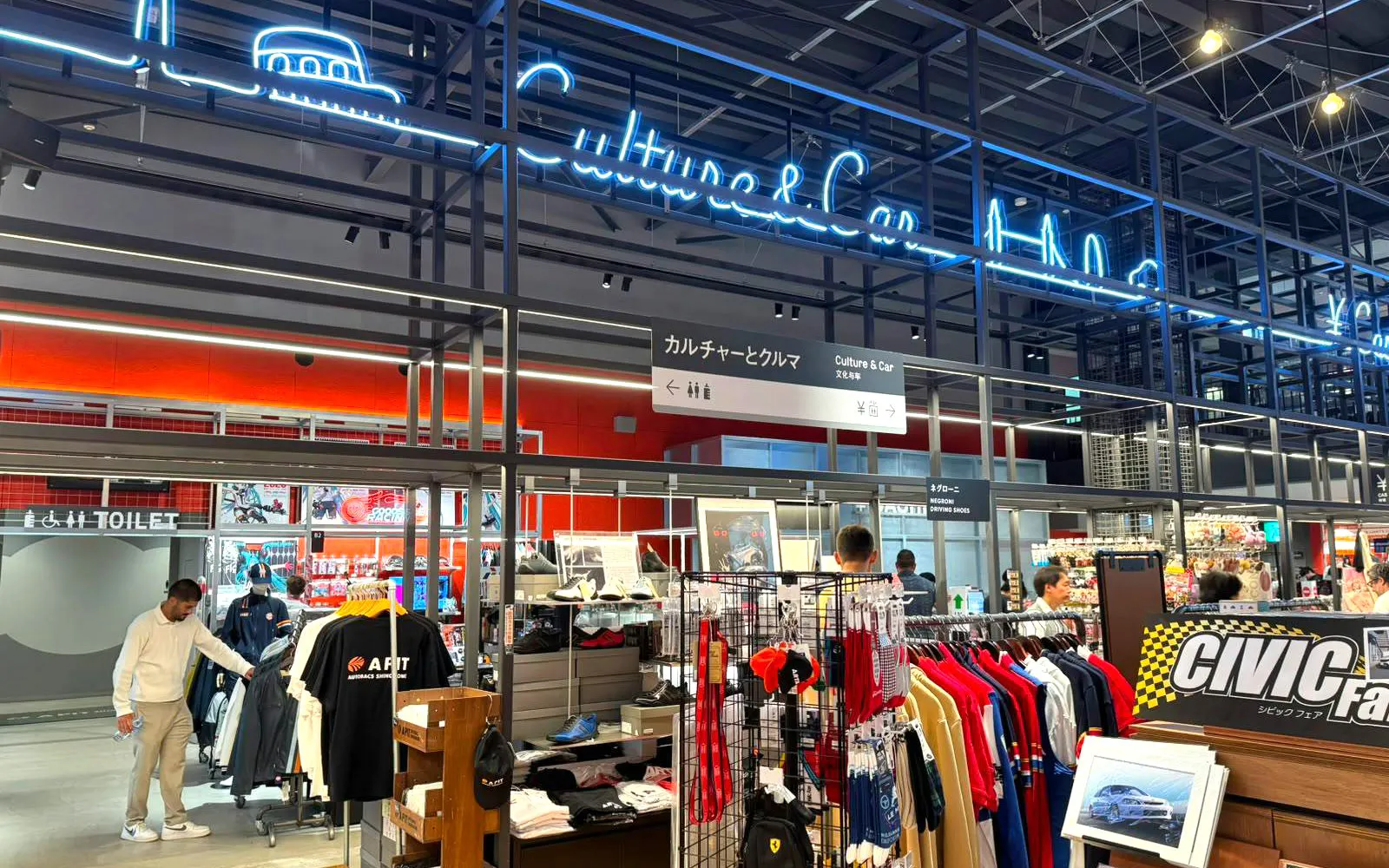 Tokyo car culture shop with merchandise and neon signs.