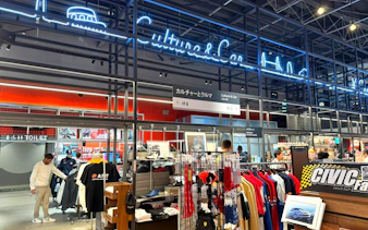 Tokyo car culture shop with merchandise and neon signs.