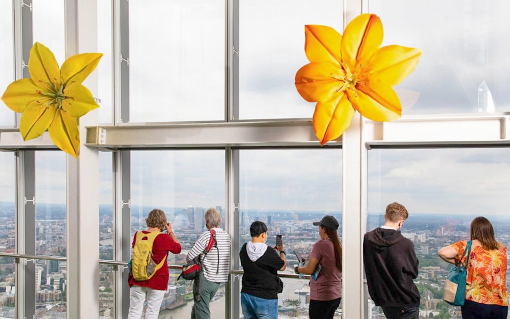 Visitors enjoying the London skyline from The Shard's observation deck.