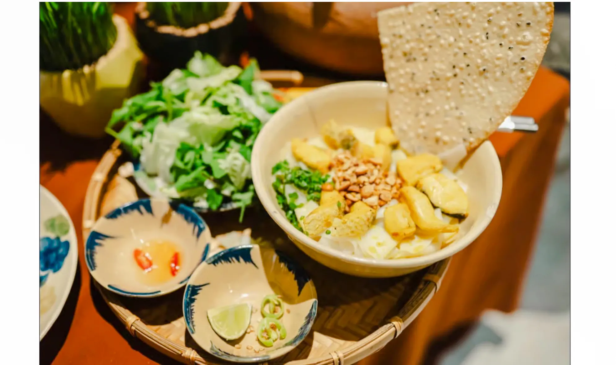 Bowl of Vietnamese street food with herbs and rice crackers, Da Nang food tour.
