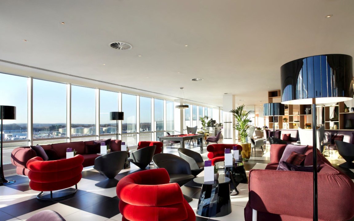 Plaza Premium Lounge seating area with large windows at London Gatwick Airport North Terminal.