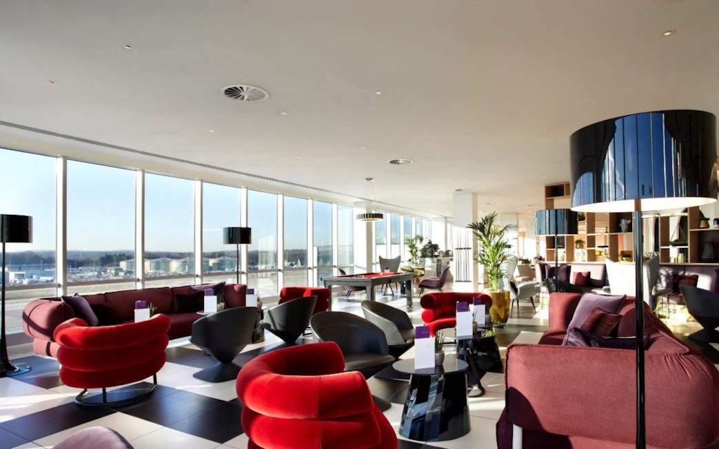 Plaza Premium Lounge seating area with large windows at London Gatwick Airport North Terminal.