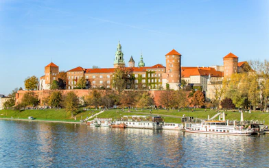 Catamaran on Vistula River with Wawel Castle in Krakow in the background.