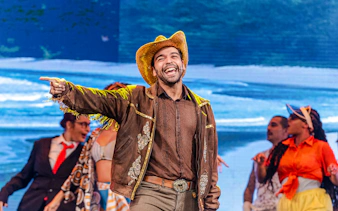 Performer in cowboy hat and jacket leading a samba show at Rio Scenarium, Rio de Janeiro.
