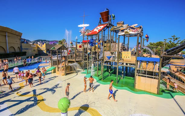 Visitors enjoying water attractions at Illa Fantasia Water Park, Barcelona.