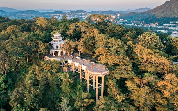 Khao Rang viewpoint in Phuket surrounded by lush greenery.