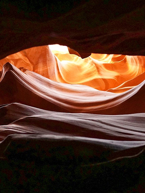 Upper Antelope Canyon's swirling sandstone formations illuminated by sunlight.