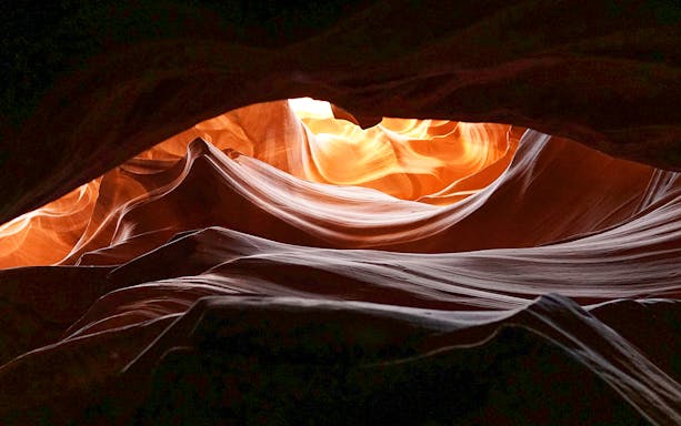 Upper Antelope Canyon's swirling sandstone formations illuminated by sunlight.