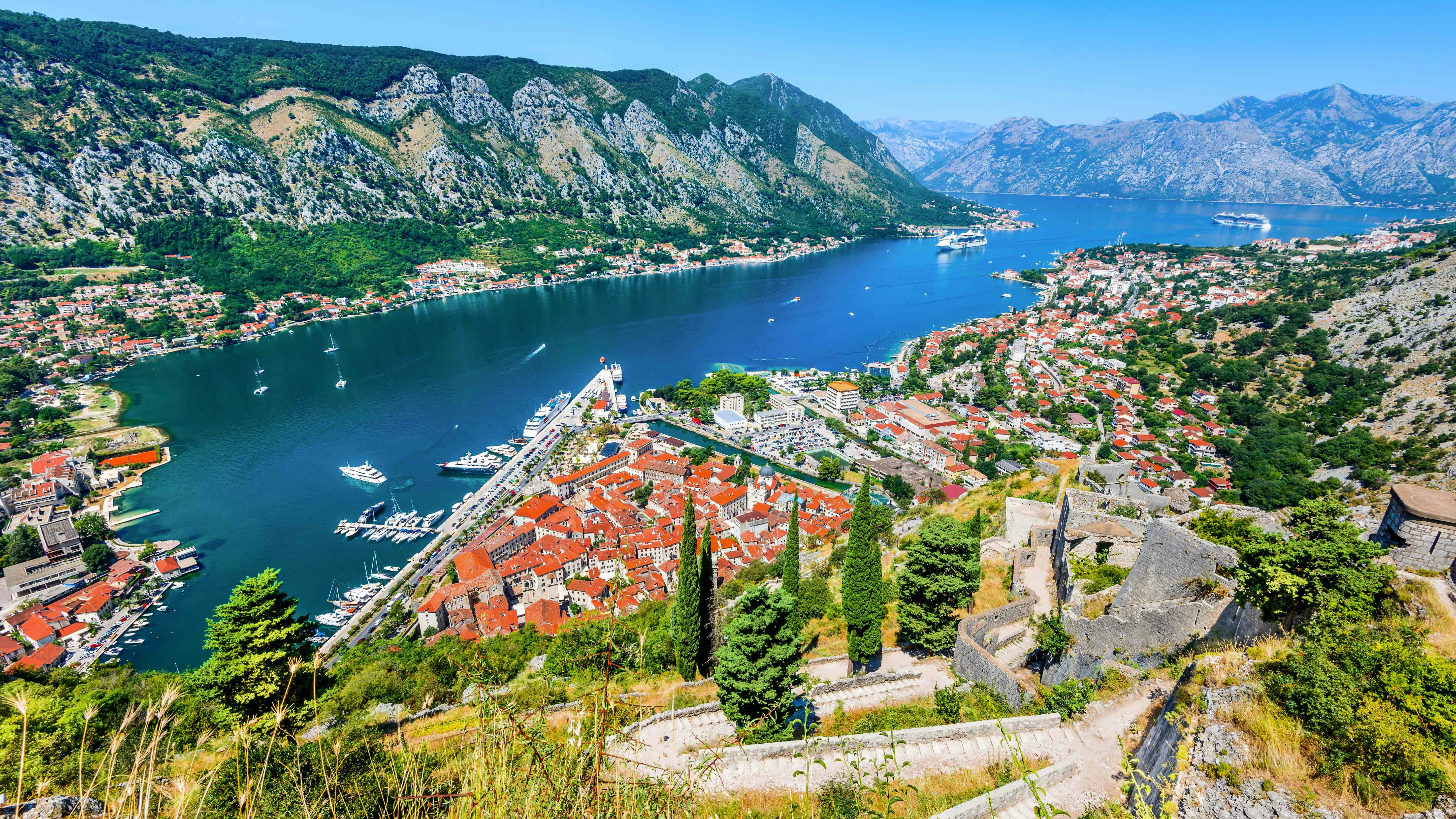 Kotor cityscape with red-roofed buildings and bay, Montenegro.