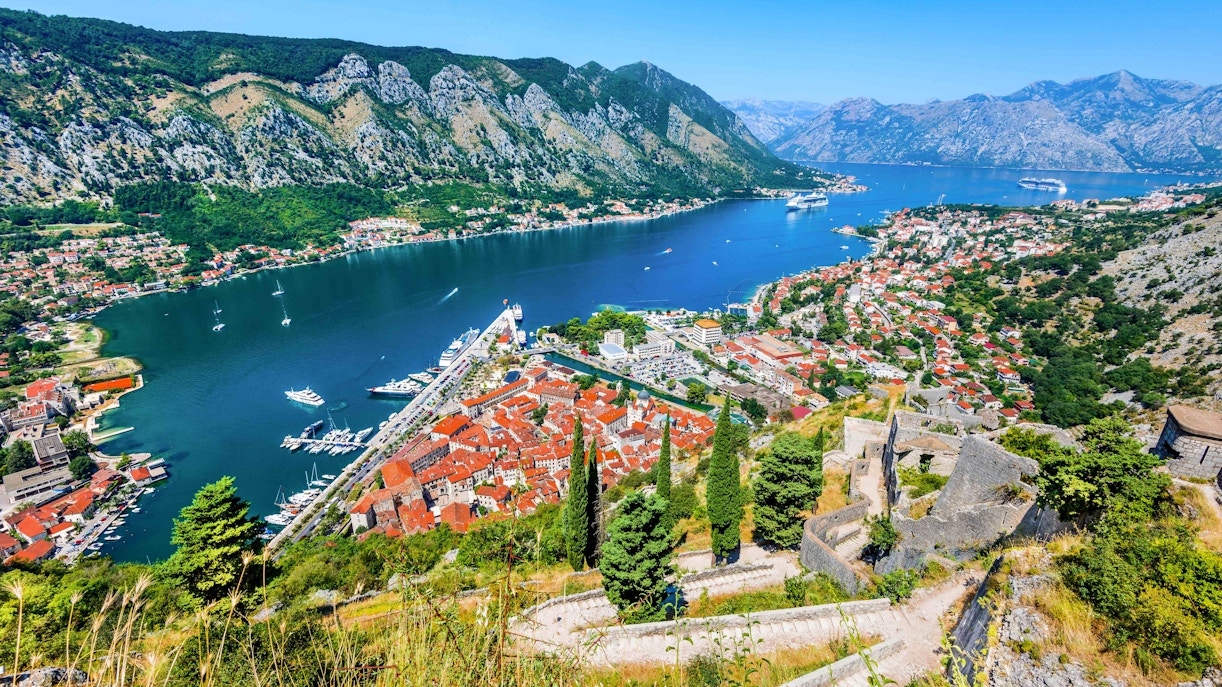 Kotor cityscape with red-roofed buildings and bay, Montenegro.