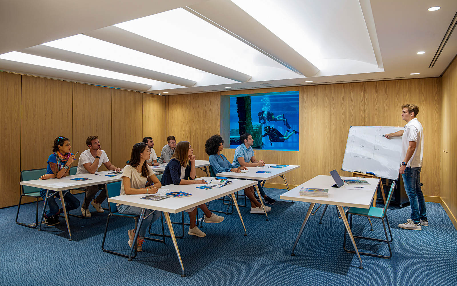 Classroom session at Deep Dive Dubai with instructor explaining diving techniques.