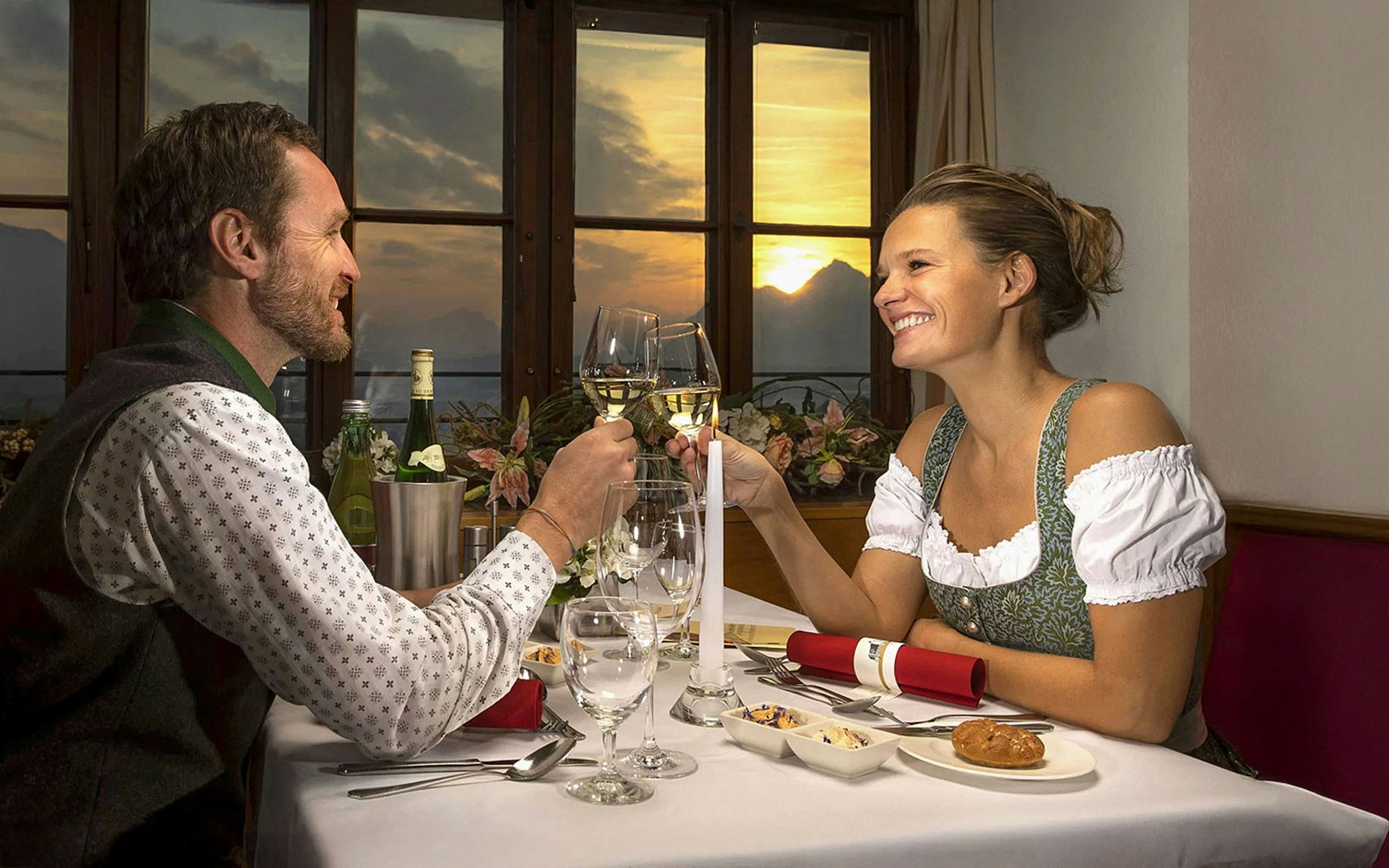 Couple dining at Fortress Hohensalzburg with view of Mozart concert setup in Salzburg.