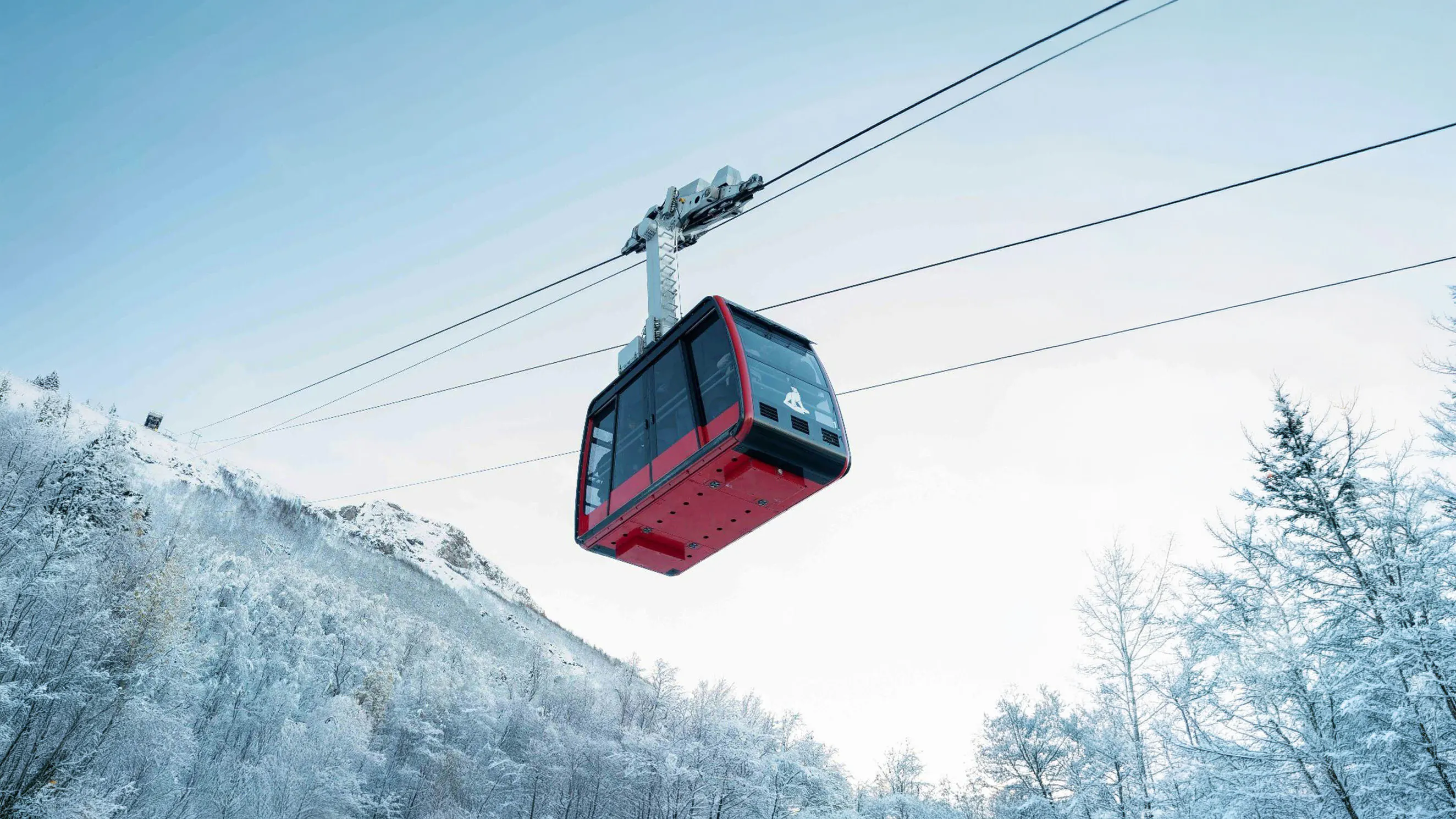Cable car ascending snowy mountain in Fjellheisen, Tromsø.