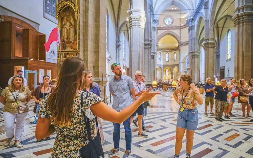 Tour group listening to guide inside Florence Cathedral.