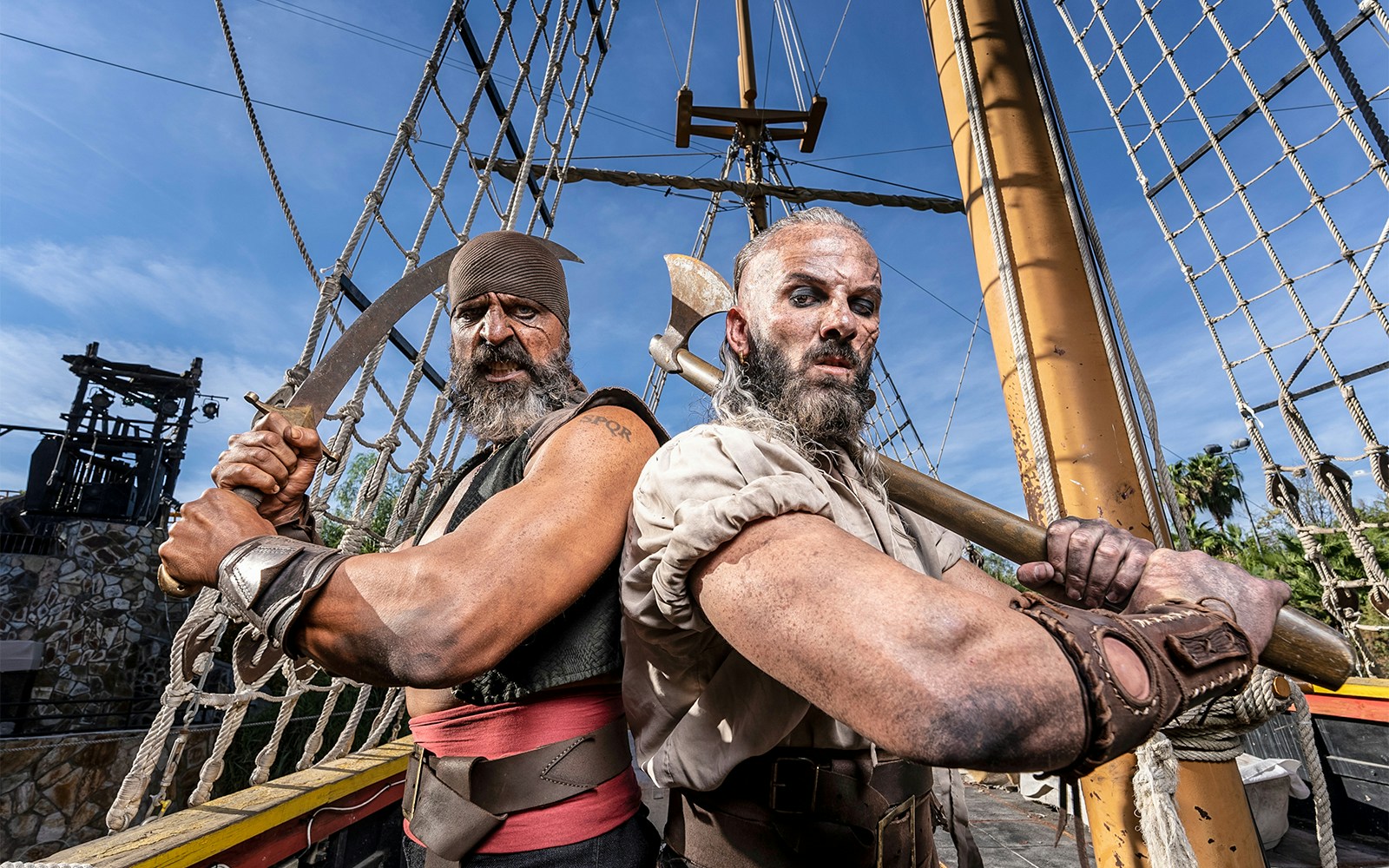 Pirates on a ship at Isla Magica, preparing for a battle with swords and axes.