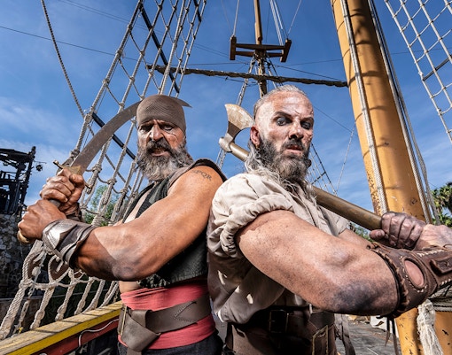 Pirates on a ship at Isla Magica, preparing for a battle with swords and axes.