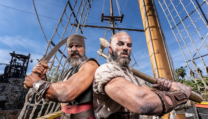 Pirates on a ship at Isla Magica, preparing for a battle with swords and axes.