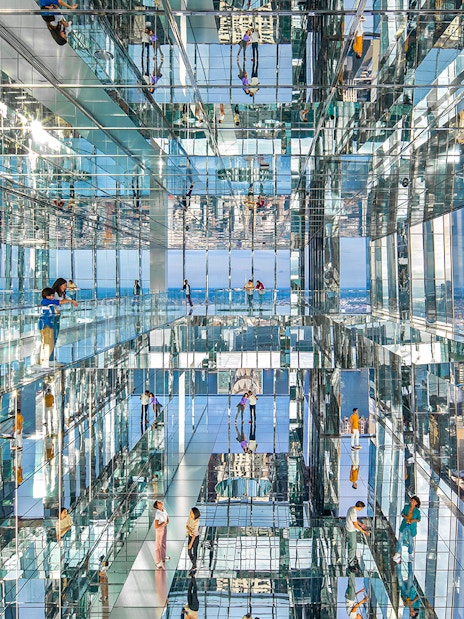 Visitors exploring mirrored observation deck at SUMMIT One Vanderbilt, New York City.