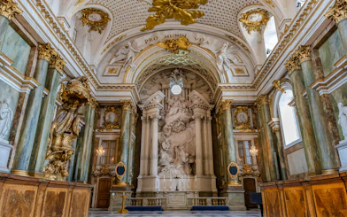 Interior view of the Royal Chapel at the Sweden Royal Palace, featuring ornate columns and sculptures.