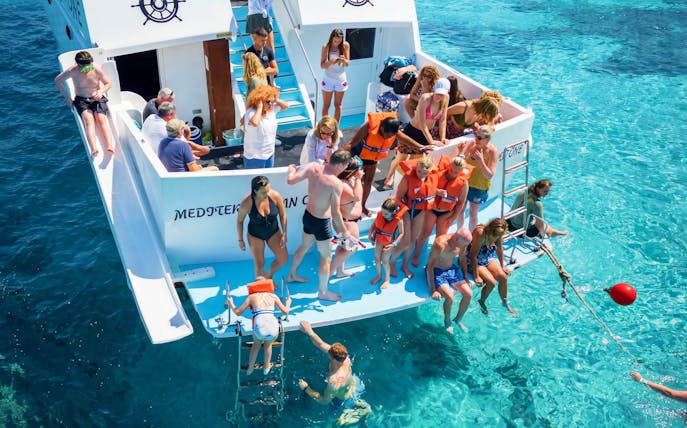 Tourists on a boat enjoying the Blue Lagoon cruise from Latchi, Cyprus.