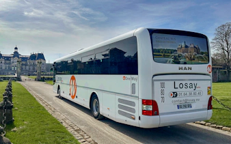 Chateaubus shuttle parked near Vaux-le-Vicomte Castle entrance.