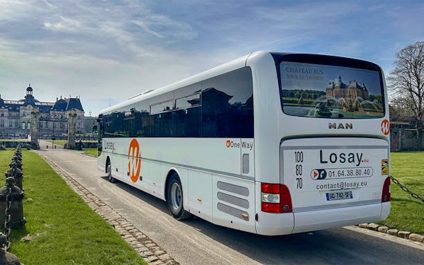 Chateaubus shuttle parked near Vaux-le-Vicomte Castle entrance.