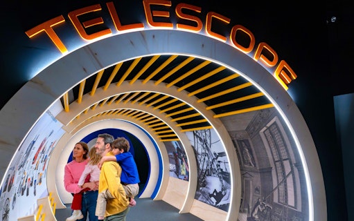 Guests exploring telescope exhibit at the National Maritime Museum event.