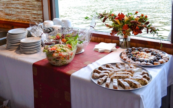 Snacks on a table aboard the historic ship Maria Croon on the Vltava River, Prague.