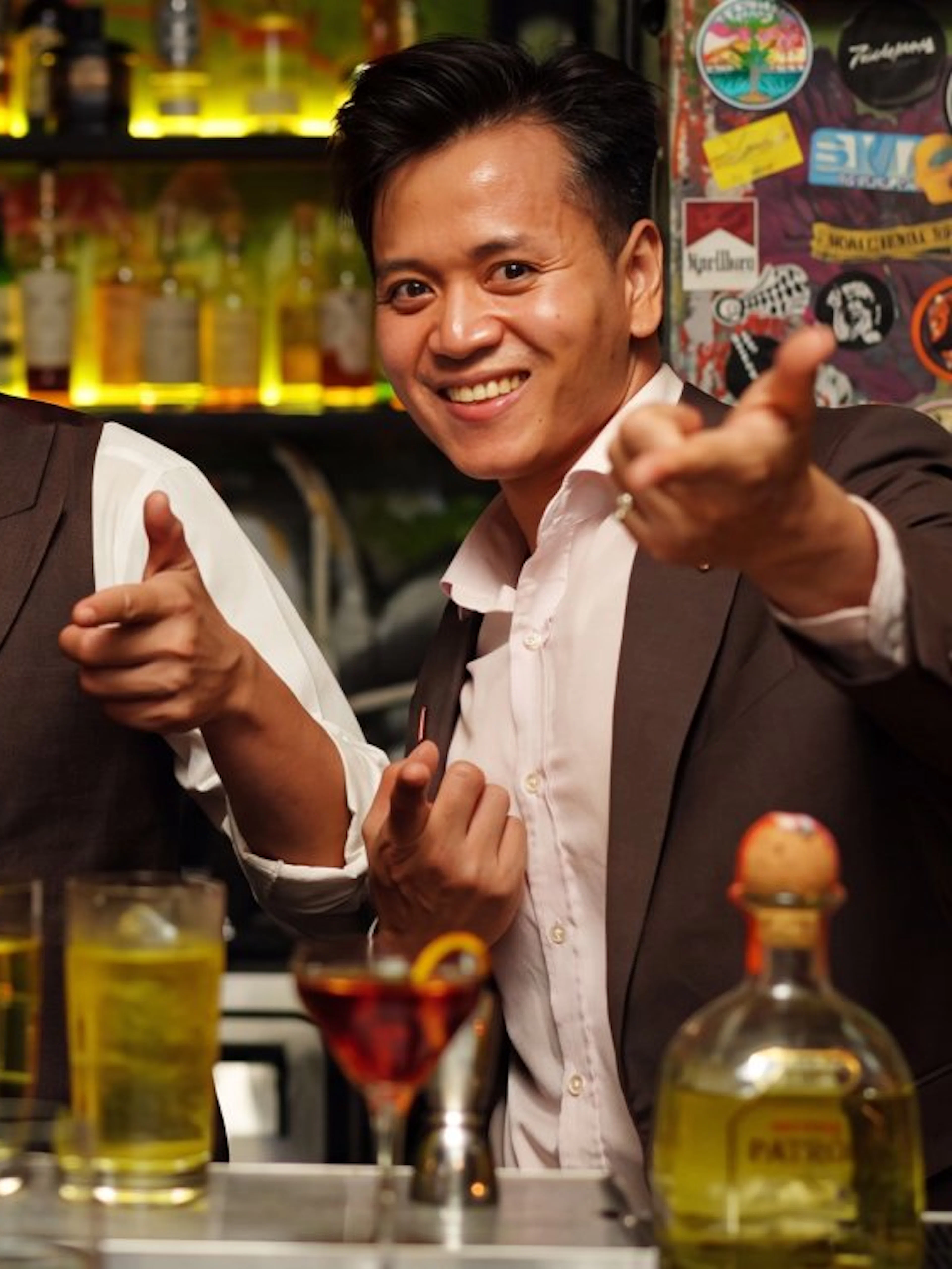 Group enjoying drinks at a lively rooftop bar during the Ultimate Nightlife Rooftop Bar Hopping tour.