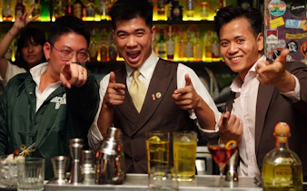 Group enjoying drinks at a lively rooftop bar during the Ultimate Nightlife Rooftop Bar Hopping tour.