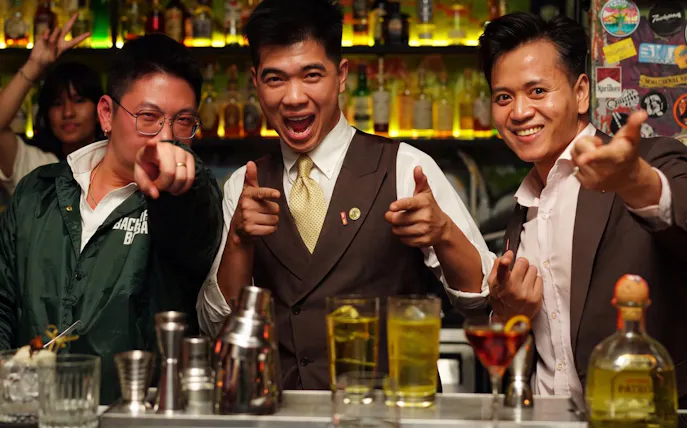 Group enjoying drinks at a lively rooftop bar during the Ultimate Nightlife Rooftop Bar Hopping tour.
