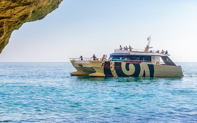 Catamaran near Benagil Caves on Algarve sightseeing cruise from Albufeira.