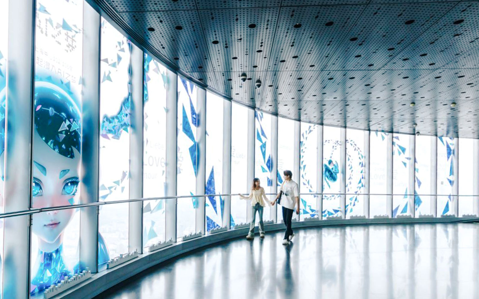 Visitors walking inside Shanghai Tower observation deck with digital art displays.