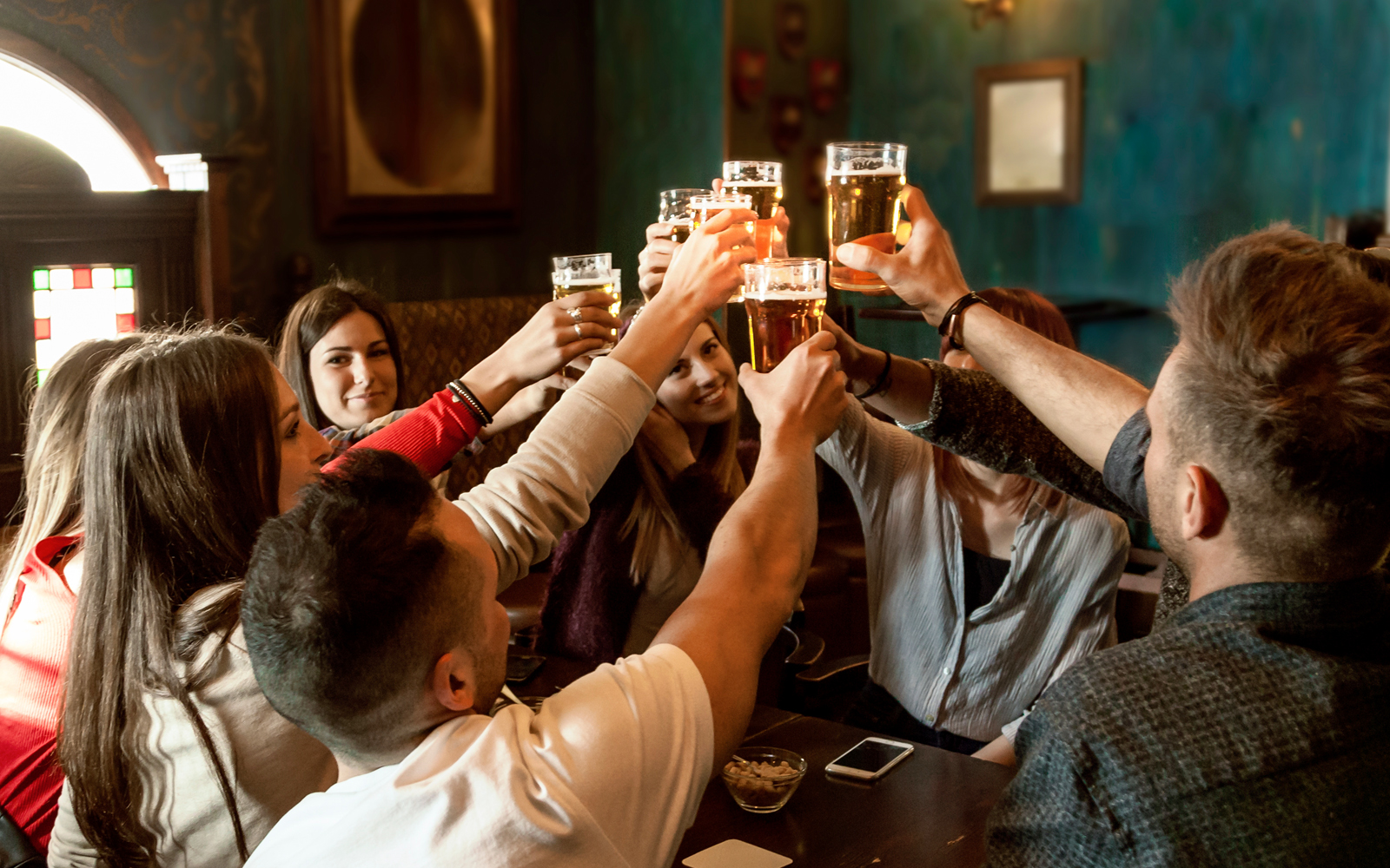 Group enjoying a pub crawl near Blue Planet Aquarium, Chester, England.
