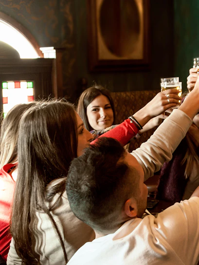 Group enjoying a pub crawl near Blue Planet Aquarium, Chester, England.