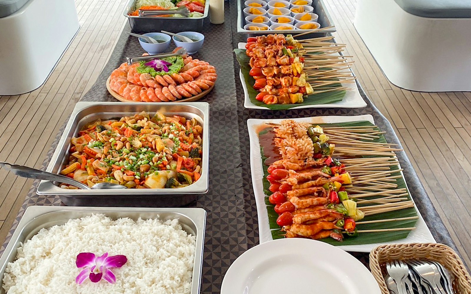 Buffet spread on yacht with skewers, shrimp, rice, and vegetables for James Bond Sunset Tour, Phuket.