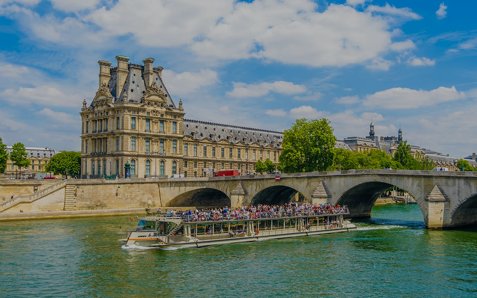 Louvre Museum viewed from Seine River cruise, Paris.