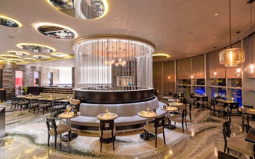 Buffet dining area at Mundo Jumeirah Emirates Towers with elegant seating and modern decor.