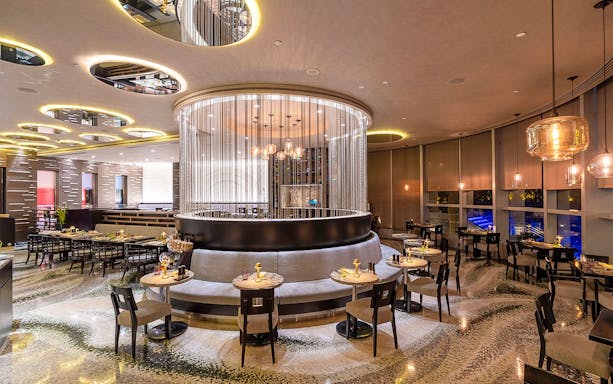 Buffet dining area at Mundo Jumeirah Emirates Towers with elegant seating and modern decor.