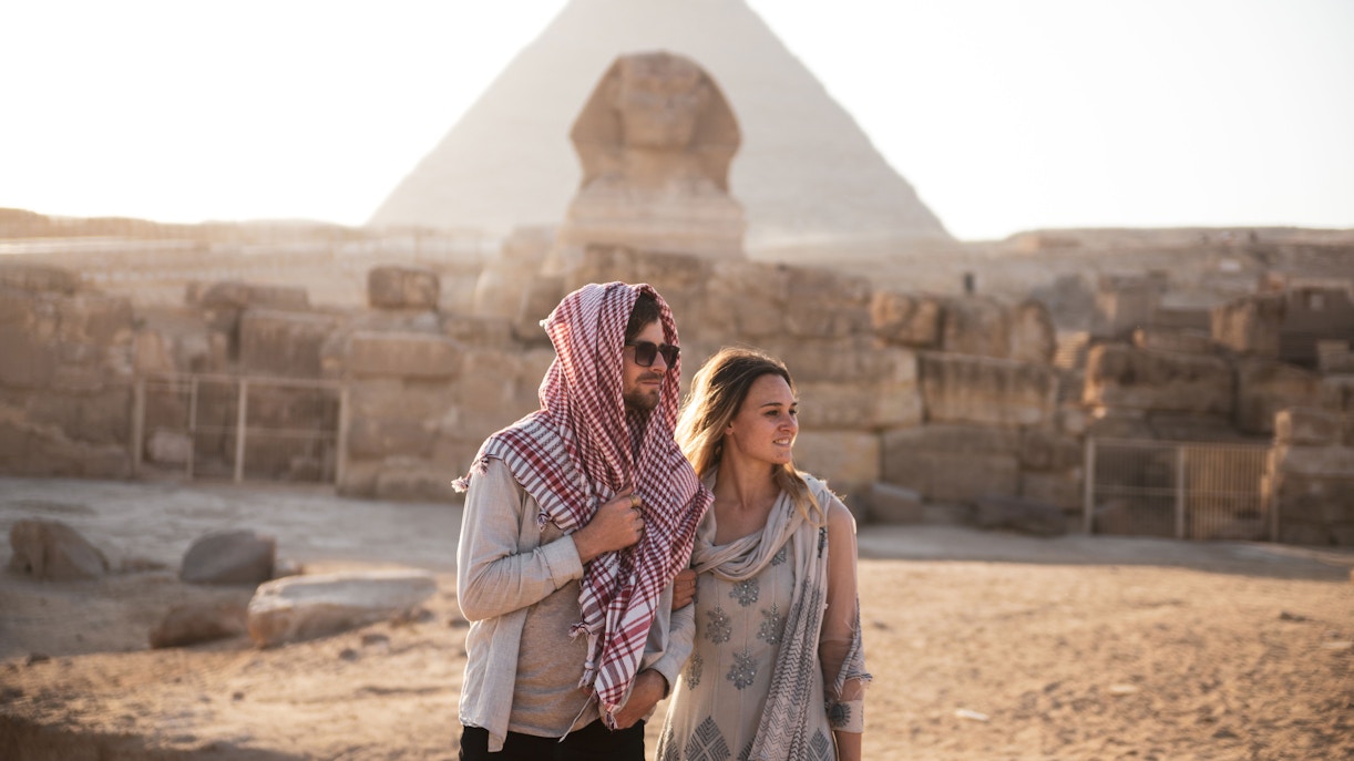 Tourists at the Sphinx with Pyramid of Giza in background, Egypt.
