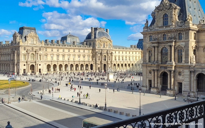 Louvre Museum exterior with courtyard and glass pyramid in Paris.